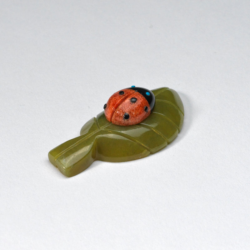 Georgette Quam & Reynold Lunasee: Apple coral, Ladybug on a Green Serpentine Leaf