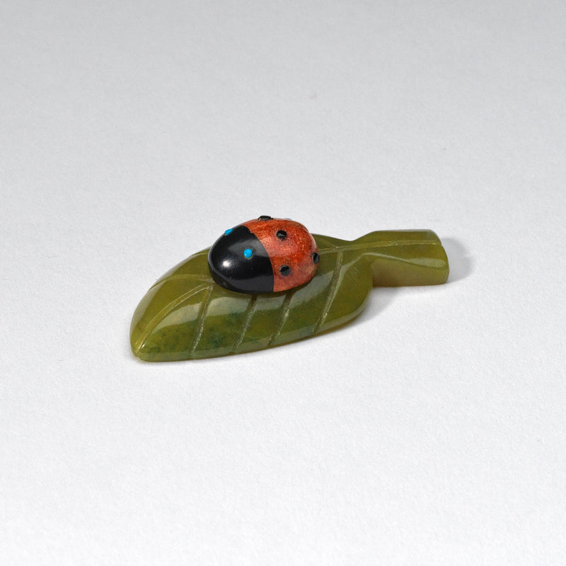 Georgette Quam & Reynold Lunasee: Apple coral, Ladybug on a Green Serpentine Leaf